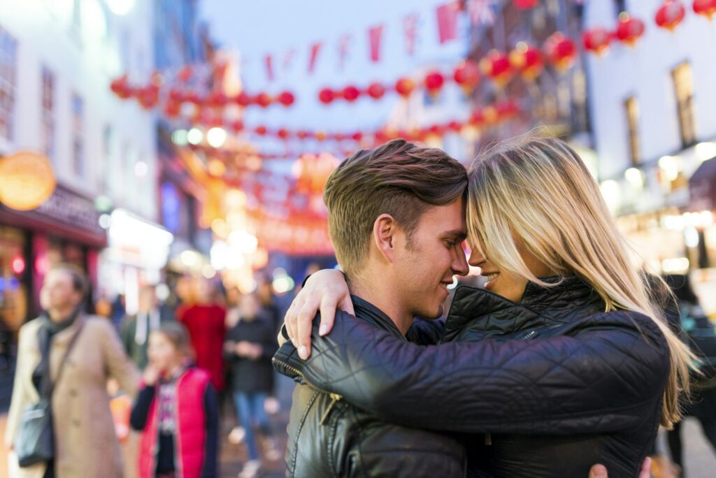 Romantic young couple hugging, Chinatown, London, England, UK